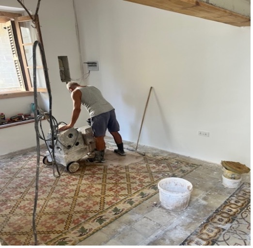Polishing original encaustic tile floors during Magdalena restoration