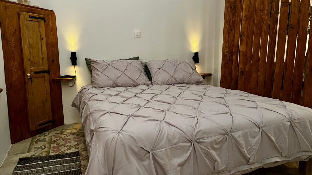 Bedroom with original timber beams at Magdalena holiday home Malta