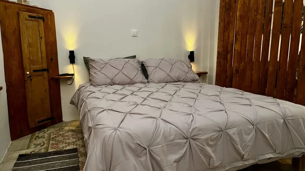 Bedroom with original timber beams at Magdalena holiday home Malta