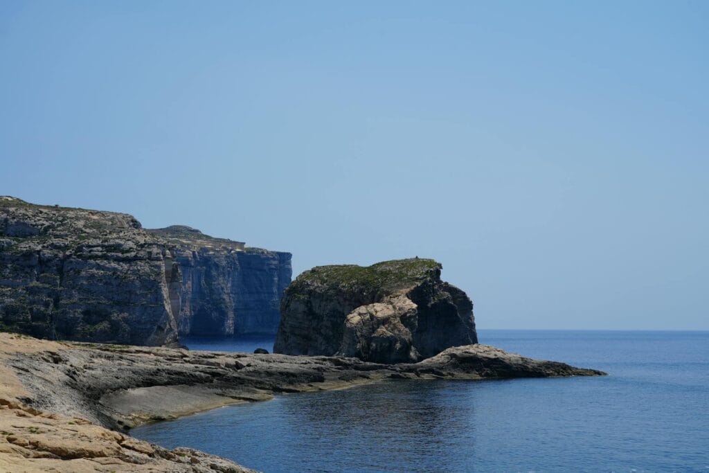Dramatic coastal cliffs with clear blue sea in Gozo, Malta
